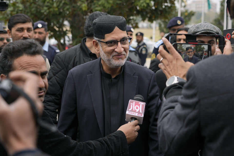 Akhtar Mengal, center, Pakistan's newly elected lawmaker from Balochistan National Party, is surrounded by members of the media as he arrives to attend the opening session of parliament, in Islamabad, Pakistan, Thursday, Feb. 29, 2024. Pakistan's National Assembly swore in newly elected members on Thursday in a chaotic scene, as allies of jailed former Premier Khan protested what they claim was a rigged election. (AP Photo/Anjum Naveed)