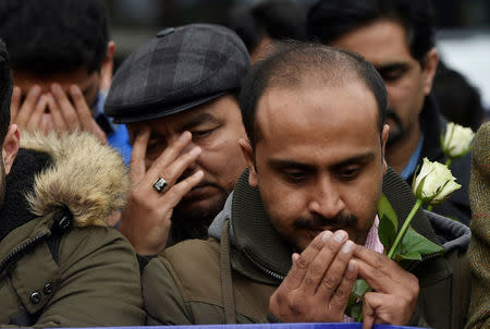 People pay their respects during an event to mark one week since a man drove his car into pedestrians on Westminster Bridge then stabbed a police officer in London, Britain March 29, 2017. REUTERS/Hannah McKay