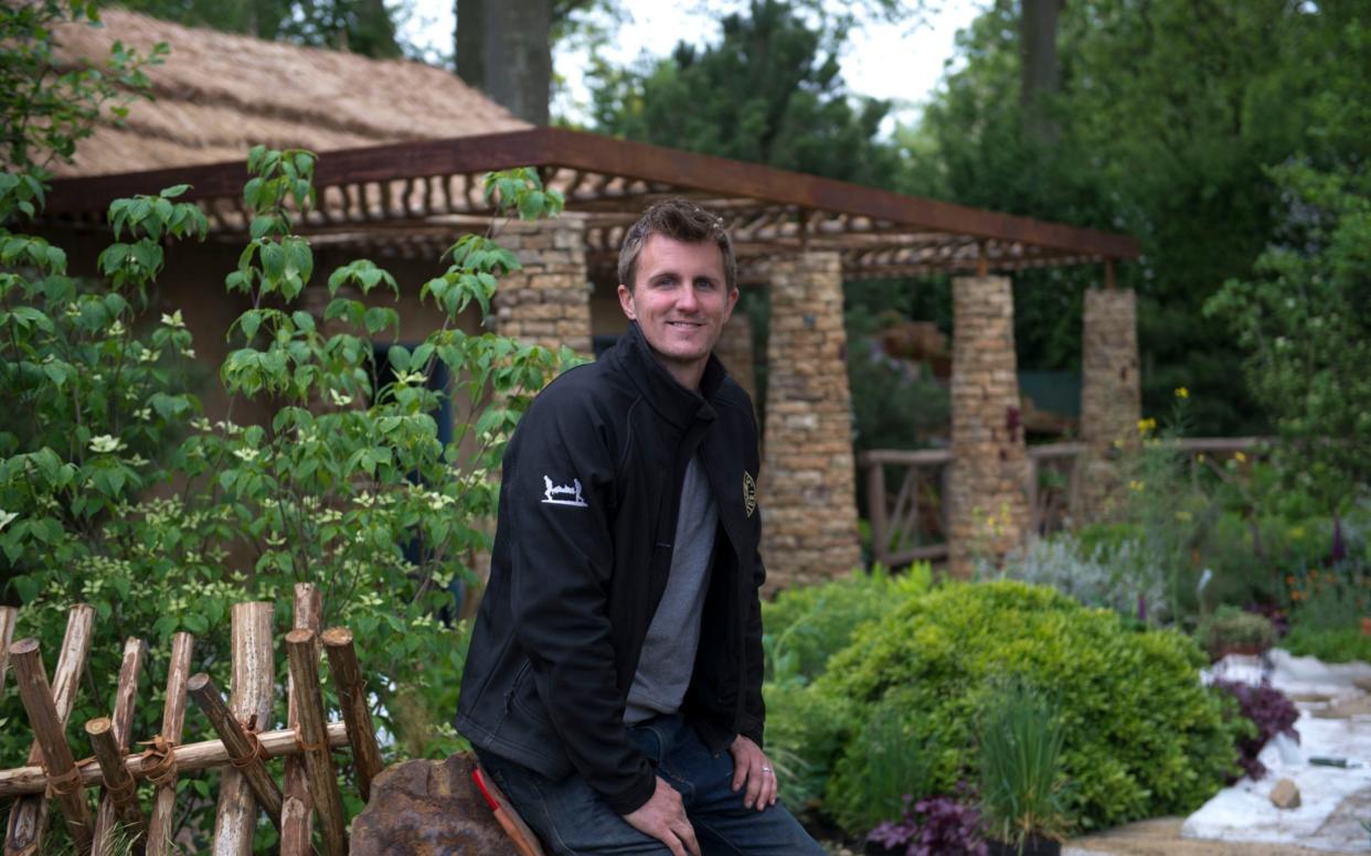  Matthew Keightley working on his garden at RHS Chelsea Flower Show - PA