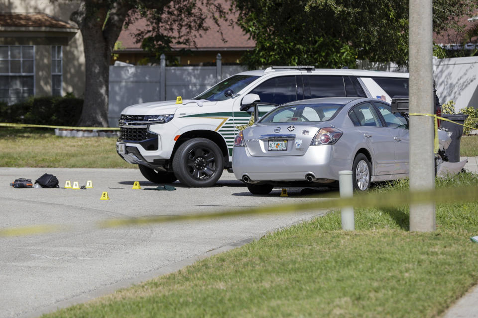 Hillsborough County Sheriff investigators on the scene of an incident where two of their own deputies were seriously injured after being struck by a vehicle while on a call for service on Thursday, Nov. 9, 2023, in Brandon, Fla. (Luis Santana/Tampa Bay Times via AP)