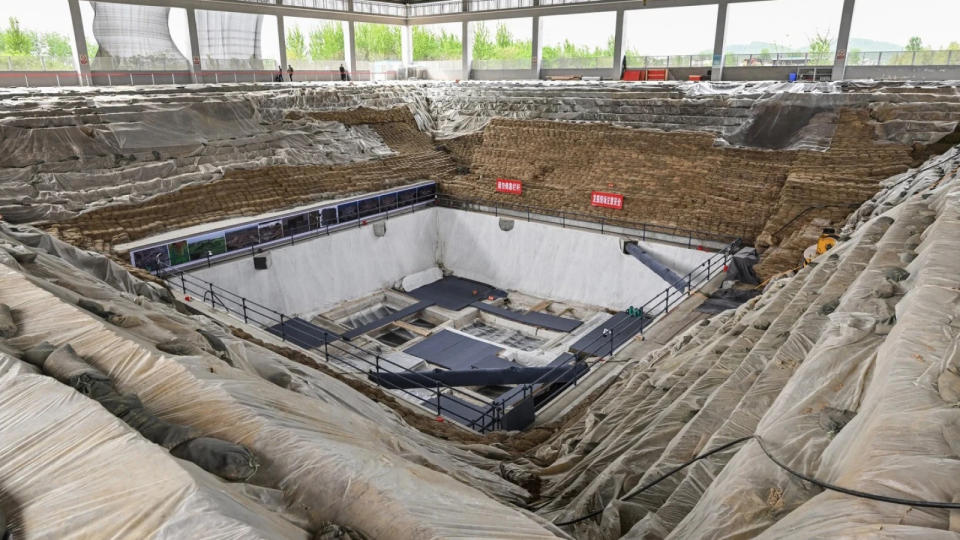 Excavation site in the center of an enclosed warehouse.