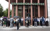 People stand outside a Starbucks Coffee shop that has been closed as police respond to a shooting at the Washington Navy Yard in Washington, September 16, 2013. The U.S. Navy said several people were injured and there were possible fatalities in the shooting at the Navy Yard in Washington D.C. on Monday. The Navy did not immediately provide additional details but a Washington police spokesman said earlier that five people had been shot, including a District of Columbia police officer and one other law enforcement officer. (REUTERS/Joshua Roberts)