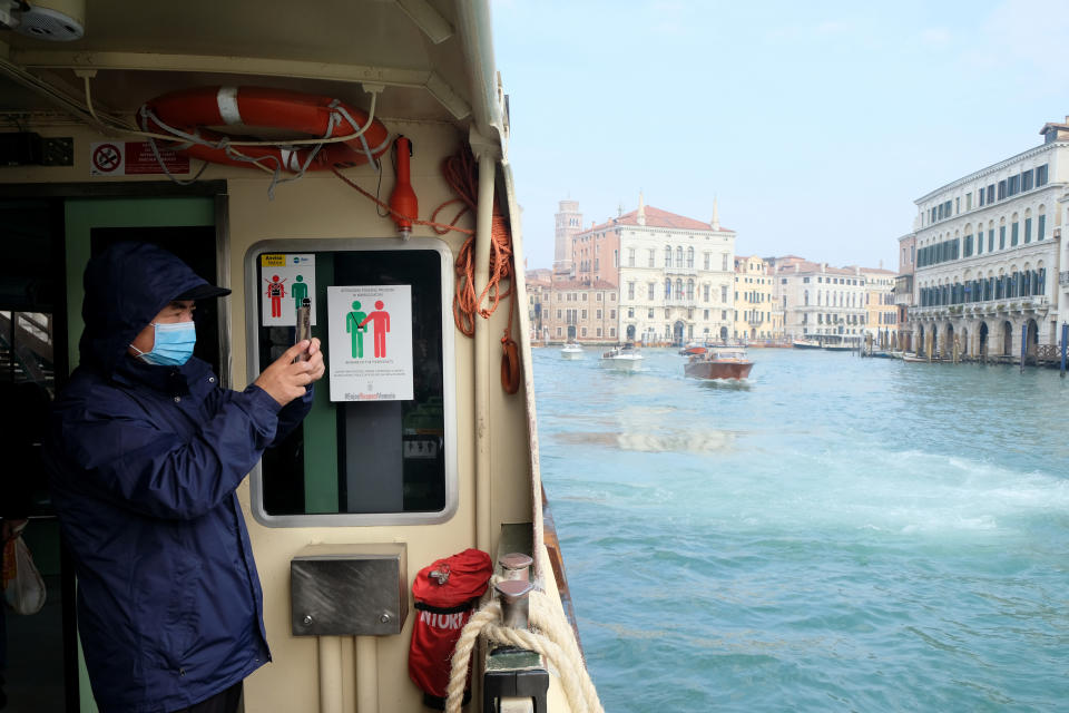 A tourist wearing a protective mask is seen inside a water bus, after two coronavirus cases have been confirmed in Italy, in Venice, Italy, January 31, 2020. REUTERS/Manuel Silvestri