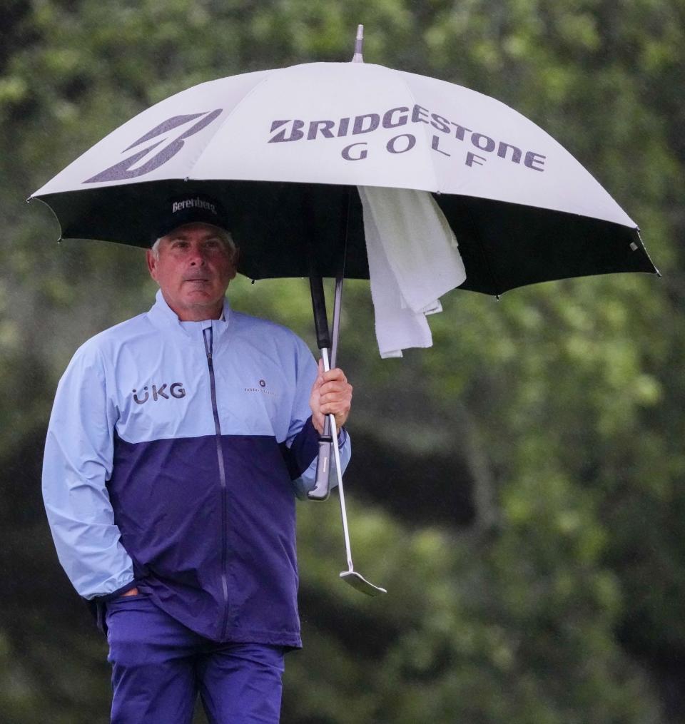 Apr 8, 2023; Augusta, Georgia, USA; Fred Couples stands under an umbrella on the 18th green during the second round of The Masters golf tournament. Mandatory Credit: Rob Schumacher-USA TODAY Network