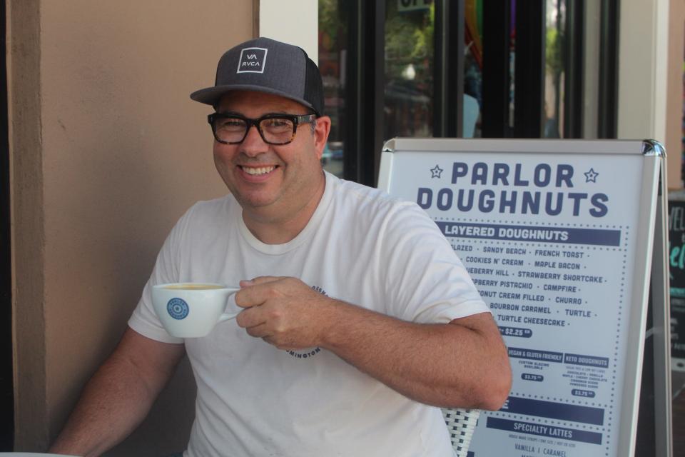 Parlor Doughnuts founder Darrick Hayden makes a stop at the new Pensacola location at 120 Palafox Place on Friday to help prepare for soft opening weekend.