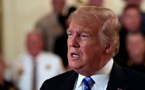 Donald Trump has lashed out at an opinion piece written by an anonymous senior official within his administration, who claimed to be part of a "resistance" seeking to curtail the president's "worst inclinations". The explosive column in the New York Times rocked the White House on Wednesday, reportedly triggering a frantic hunt for the author of the article. According to the “senior administration official”, whose opinion piece was called "gutless" by Mr Trump, members of the president's cabinet were so worried by his erratic, impulsive behaviour they discussed using extreme constitutional measures to remove him from power. The 25th amendment is designed to be used in the case of an incapacitated commander-in-chief. However, the op-ed claims that senior figures considered deploying it to oust the president. “Given the instability many witnessed, there were early whispers within the cabinet of invoking the 25th amendment, which would start a complex process for removing the president,” writes the anonymous author. “But no one wanted to precipitate a constitutional crisis.” Instead a cabal of senior figures is now working to thwart the president’s more “misguided impulses” or “worst inclinations”, claims the writer, whose article is headlined “I Am Part of the Resistance Inside the Trump Administration”. Mr Trump dismissed the article as the product of someone who was probably failing in their job. “He’s part of the resistance. This is what we have to deal with,” he told reporters at the White House. Mr Trump added: "Anonymous. Can you believe it? Anonymous. Meaning gutless. A gutless editorial." The President later issued a one-word tweet reading: "TREASON?", before demanding the New York Times turn over the author "for national security purposes". TREASON?— Donald J. Trump (@realDonaldTrump) September 5, 2018 Does the so-called “Senior Administration Official” really exist, or is it just the Failing New York Times with another phony source? If the GUTLESS anonymous person does indeed exist, the Times must, for National Security purposes, turn him/her over to government at once!— Donald J. Trump (@realDonaldTrump) September 5, 2018 Sarah Sanders, White House spokeswoman, branded the piece "pathetic, reckless, and selfish" and condemned the Times for publishing it. "Nearly 62 million people voted for President Donald J. Trump in 2016," said Sanders. "None of them voted for a gutless, anonymous source to the failing New York Times." The White House is now reportedly trying to hunt down the author of the article. The phrase, “The sleeper cells have awoken,” circulated on text messages among aides and outside allies, according to the Washington Post. “It’s like the horror movies when everyone realises the call is coming from inside the house,” one former White House official in close contact with former co-workers told the newspaper. President Donald Trump responds to a reporters question during an event with sheriffs in the East Room of the White House in Washington, Credit: AP One current official told the Post: “The problem for the president is it could be so many people. You can’t rule it down to one person. Everyone is trying, but it’s impossible.” The claims follow revelations in Bob Woodward’s new book, Fear: Trump in the White House, that officials have snatched papers from the president’s desk to prevent him signing off on what they believe to be dangerous proposals. It also corroborates earlier accounts of a chaotic White House, where decision-making follows erratic impulses. It claims John Kelly, White House chief of staff, disparaged Mr Trump as an “idiot” and suggested the presidency was in “crazytown”. Jim Mattis, the defence secretary, reportedly told associates that the president had the understanding of a “fifth or sixth-grader”. At a glance | 25th Amendment Both men denied having said any such thing and a string of other figures lined up to offer their own denials. But the broader account of a White House careening towards what Mr Woodward described as a “nervous breakdown” chimes with previous accounts of an administration in crisis. And the New York Times opinion piece will add to a sense of unprecedented turmoil at the heart of American democracy, where officials fear anything could happen next. The writer says the trouble stems from the president’s “amorality” and a leadership style that is “impetuous, adversarial, petty and ineffective”. “Meetings with him veer off topic and off the rails, he engages in repetitive rants, and his impulsiveness results in half-baked, ill-informed and occasionally reckless decisions that have to be walked back,” he or she writes. Bob Woodward’s book on Trump | The most explosive claims They go on to describe a two-track system of government, in which Mr Trump shows preference for autocrats and dictators – such as Vladimir Putin or Kim Jong-un – while other departments follow more conventional policy. “It may be cold comfort in this chaotic era, but Americans should know that there are adults in the room,” the piece continues. “We fully recognise what is happening. And we are trying to do what’s right even when Donald Trump won’t.” Although many White House players have been cast as villains, privately they are working for the good of the country, it continues. Not because they are part of a liberal “deep state” but because they are part of the “steady state”. Mr Woodward has written about every president since Richard Nixon Credit: Reuters The account chimes with anecdotes in Mr Woodward's book. He describes how Gary Cohn, the former White House chief economics adviser, reportedly boasted to colleagues of removing worrying documents - withdrawing the US from an important trade deal with South Korea, for example - from Mr Trump's desk before he could sign them. The latest leaked account will heap further pressure on Mr Trump. Insiders say he is furious at Mr Woodward’s book and the barbs directed his way by senior aides. The White House was forced once again into a defensive crouch amid reports officials had struggled to get hold of a copy hours after news broke of its contents. Donald Trump approval rating tracker “Isn’t it a shame that someone can write an article or book, totally make up stories and form a picture of a person that is literally the exact opposite of the fact, and get away with it without retribution or cost,” wrote Mr Trump on Twitter. “Don’t know why Washington politicians don’t change libel laws?” The arrival of Mr Woodward's book, due for publication next Tuesday, had been anticipated for weeks and he followed his own, familiar timetable in releasing its contents to The Washington Post in advance. Still, the administration appeared caught off guard. Philip Rucker, Washington Post's White House bureau chief, said the denials so far focused on only a tiny number of specific incidents. “They are not litigating very many details of the reporting and there’s a feeling inside that the president is really upset about this - verging on paranoia - that he’s very bothered about what’s been said about him to Woodward,” he told MSNBC’s Morning Joe. The Woodward book is just more self-serving whinges from disgruntled Trump insiders Rich Galen, a veteran Republican strategist, said the contents may not have that sort of impact but could profoundly affect November’s midterm elections. “It’s not so much an issue of impeachment but, if the book has legs this close to the midterms, what it may do is suppress the vote of people who might otherwise shrug and say they’ll vote for the Republican because that’s what they always do,” he said. “They might just stay home and that’s exceedingly dangerous for Republicans.”