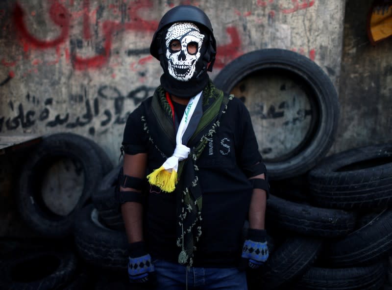 Hossam, an Iraqi demonstrator, poses for a photograph during the ongoing anti-government protests in Baghdad