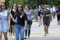 People go massless on the Atlanta Beltline on Friday, May 14, 2021, after the CDC updated their mask guidelines for COVID-19 vaccinated people. (AP Photo/Ben Gray)