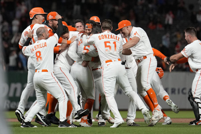 San Francisco Giants' Brandon Crawford celebrates with teammates after hitting a single to drive in the winning run against the New York Mets during the ninth inning of a baseball game in San Francisco, Tuesday, May 24, 2022. The Giants win 13-12. (AP Photo/Tony Avelar)