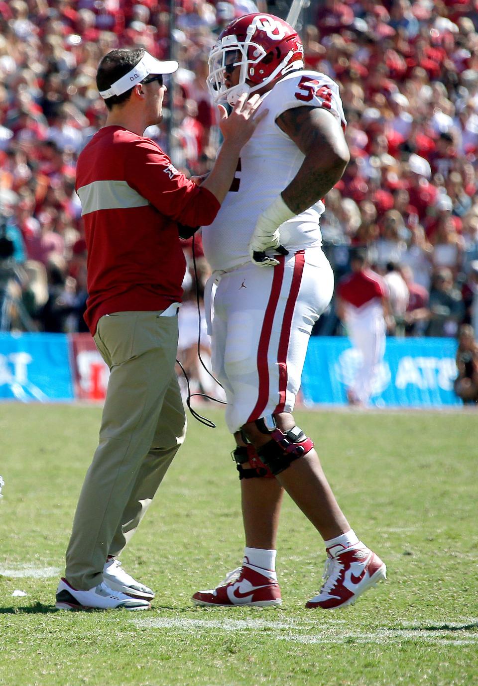 Oklahoma head coach Lincoln Riley talks with Marquis Hayes (54) in the fourth quarter during the Red River Showdown college football game between the University of Oklahoma Sooners (OU) and the Texas Longhorns (UT) at Cotton Bowl Stadium in Dallas, Saturday, Oct. 12, 2019. OU won 34-27.