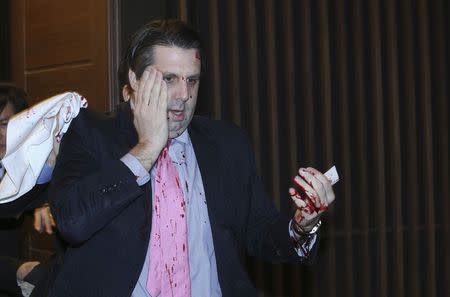 U.S. ambassador to South Korea Mark Lippert leaves after he was slashed in the face by an unidentified assailant at a public forum in central Seoul March 5, 2015. REUTERS/Yonhap