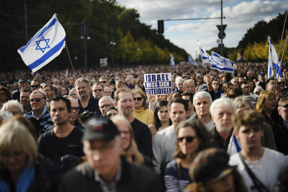 A woman shows a poster reading: "Israel must defend itself" a demonstration against antisemitism and to show solidarity with Israel in Berlin, Germany, Sunday, Oct. 22, 2023. (AP Photo/Markus Schreiber)