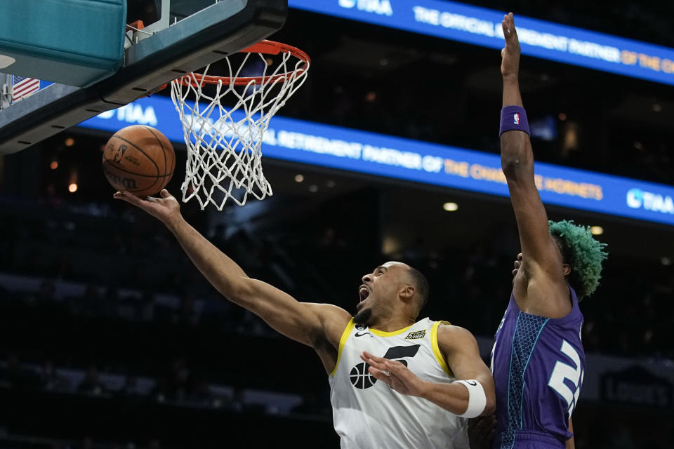 Utah Jazz guard Talen Horton-Tucker scores past Charlotte Hornets forward Kai Jones during the first half of an NBA basketball game on Saturday, March 11, 2023, in Charlotte, N.C. (AP Photo/Chris Carlson)