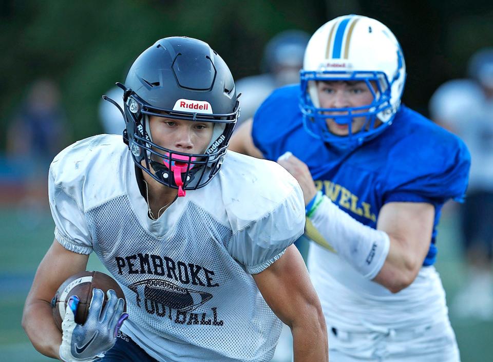 Pembroke Titan Will McNamara makes a cut up field for a first down during a scrimmage against Norwell on Friday, Sept. 2, 2022.