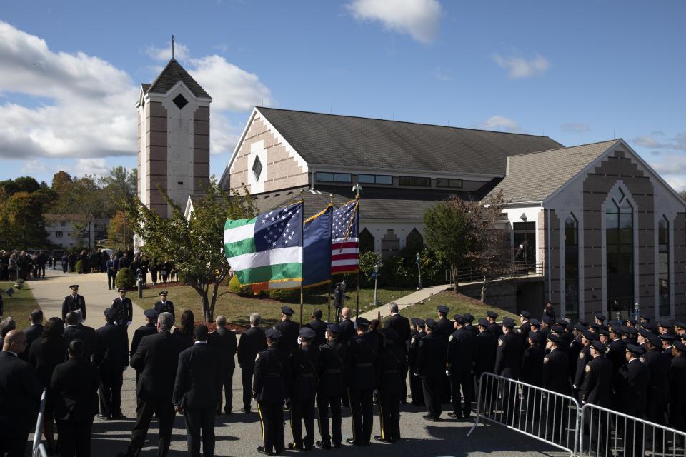 Police officers line the street in front of Church of the Sacred Heart, Friday, Oct. 4, 2019 in Monroe, N.Y., for the funeral service for New York City Police Officer Brian Mulkeen. Authorities say Mulkeen was fatally hit Sunday by two police bullets while struggling with an armed man in the Bronx. He is the second New York City officer killed by friendly fire this year. (AP Photo/Mark Lennihan)