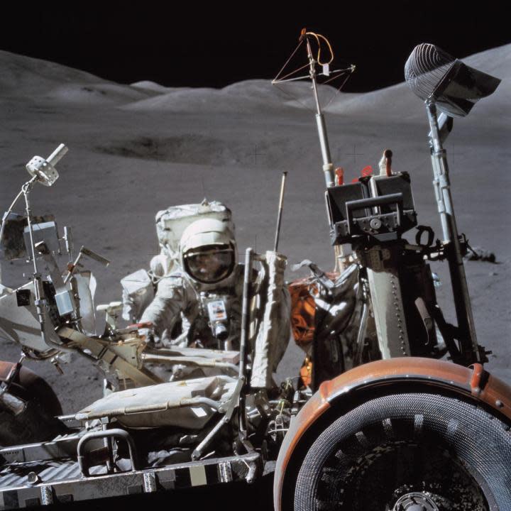 (13 Dec. 1972) — Astronaut Harrison H. Schmitt, lunar module pilot, works near the Lunar Roving Vehicle (LRV) during the third Apollo 17 extravehicular activity (EVA) at the Taurus-Littrow site on the lunar surface. The front part of the LRV is out of frame at left, but the seats and several geological tools can be seen. (NASA)