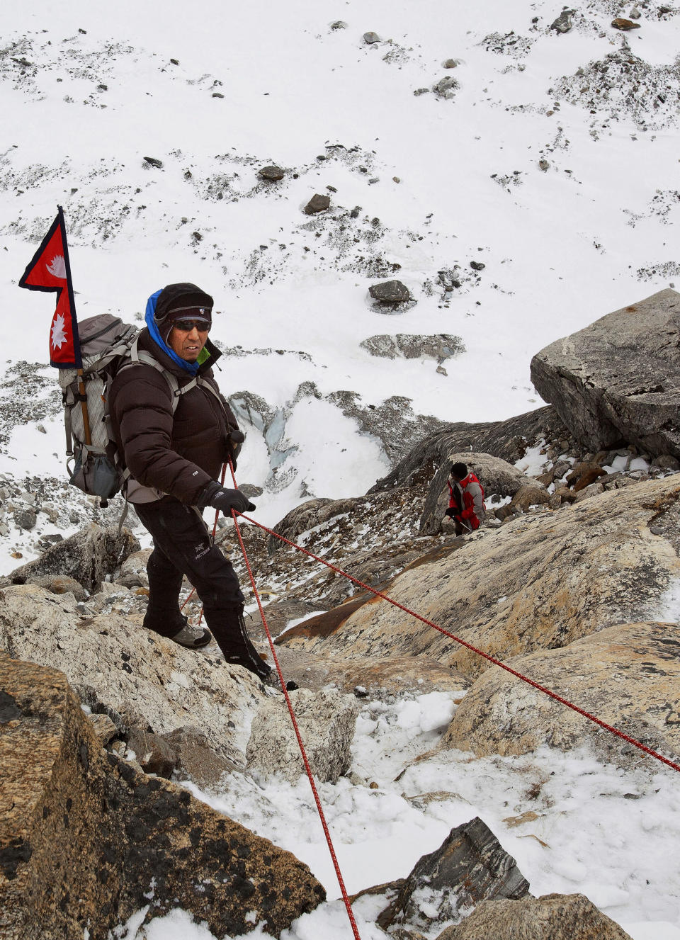 In this photo taken on Feb. 13, 2012 and released by The Great Himalayan Trail, veteran climber Apa Sherpa climbs the Himalayan mountains on the way to the Tshorolpa Glacier Lake, Nepal. The 51-year-old Apa is on a 120-day trek across Nepal to tell villagers about the danger of more devastating flash floods as glacial melt caused by climate change fills high-altitude lakes to the bursting point. (AP Photo/The Great Himalayan Trail) EDITORIAL USE ONLY