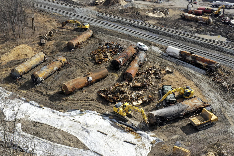 FILE - Cleanup continues on Feb. 24, 2023, at the site of a Norfolk Southern freight train derailment that happened on Feb. 3 in East Palestine, Ohio. Norfolk Southern is backing away from its push to reduce its train crews down to one person, the company said, Thursday, March 23, 2023, in a joint announcement with the nation’s largest rail union. (AP Photo/Matt Freed, File)
