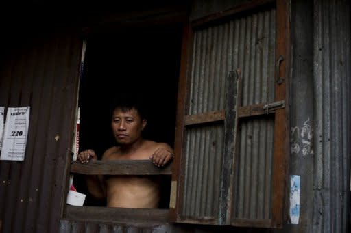 A man stands at the window of his shack in a Bangkok slum. Asia could be as wealthy as Europe by mid-century, but only if it tackles key challenges from inequality and corruption to climate change, an Asian Development Bank study said Tuesday