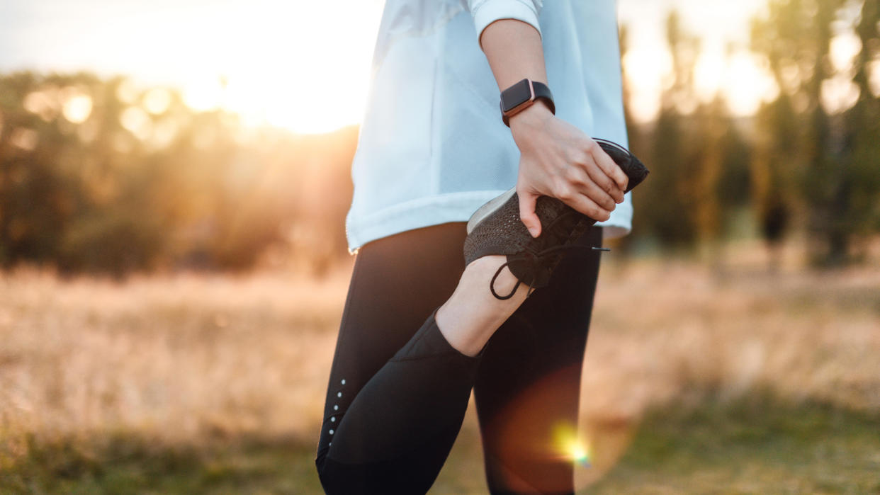  Person stretching leg before a run. 