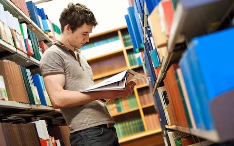 Student in a library - Credit: Alamy