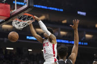 Houston Rockets forward Kenyon Martin Jr. (6) dunks next to Sacramento Kings guard Malik Monk (0) during the first half of an NBA basketball game in Sacramento, Calif., Wednesday, Jan. 11, 2023. (AP Photo/José Luis Villegas)