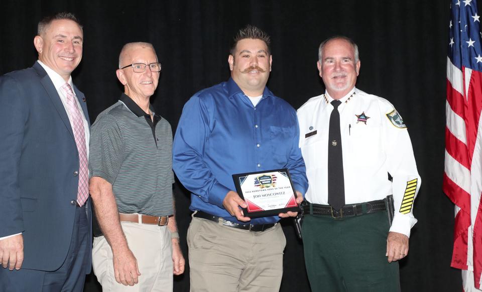 Flagler County Fire Rescue's Jon Moscowitz, second from the right, receives the 2022 "Hometown Hero of the Year" award at The Daytona Beach News-Journal's fourth annual Hometown Heroes awards dinner at the Ocean Center in Daytona Beach on Friday, Oct. 28. 2022. Also pictured from left to right: presenting sponsor Sam Royer of Heroes First Home Loans, Flagler County Fire Rescue Chief Mike Tucker, and Flagler County Sheriff Rick Staley.