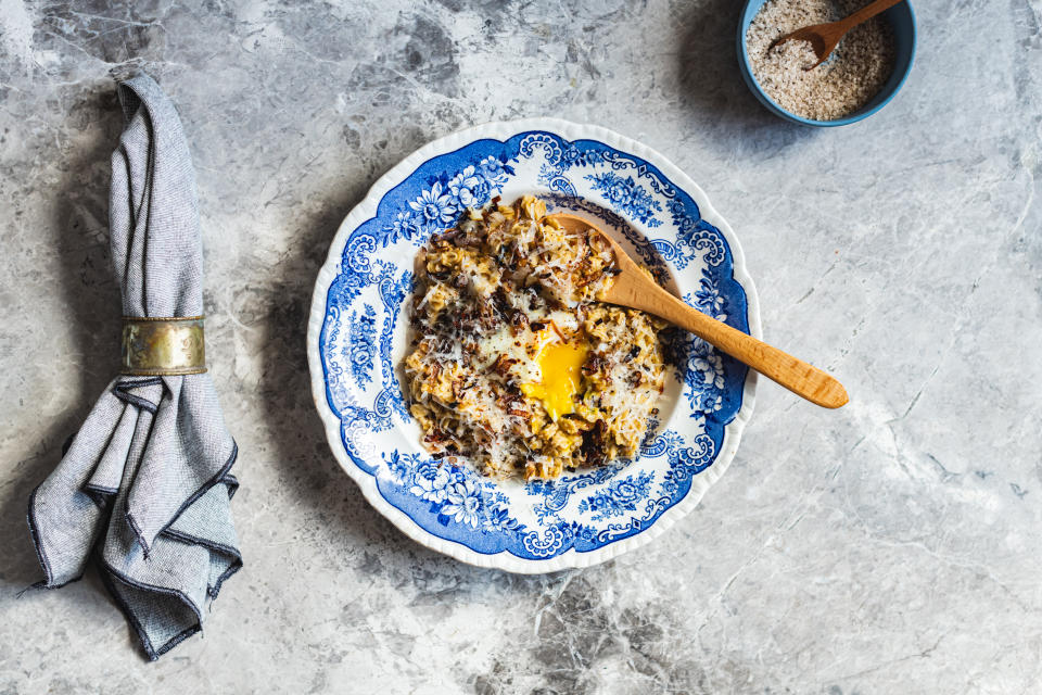 Savory oats, like the ones seen here with eggs, can help prevent sugar crashes later in the day. (Photo: Hein Van Tonder / EyeEm via Getty Images)