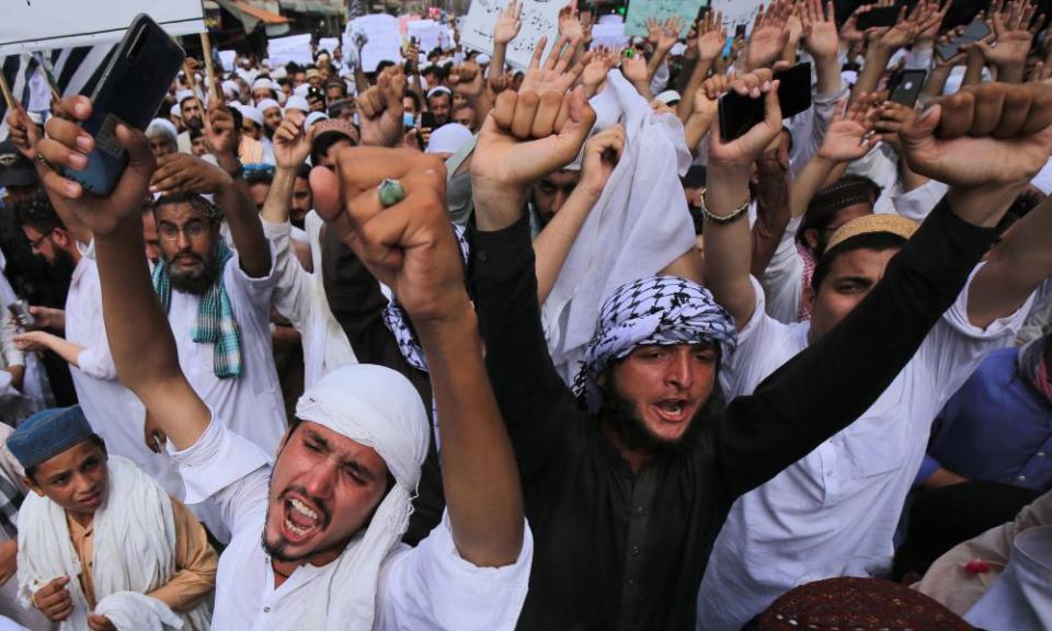 People shout slogans during a protest to support Khalid Khan, the man who killed Tahir Naseem, a man accused of blasphemy inside a court, in Peshawar, Pakistan, on 31 July.