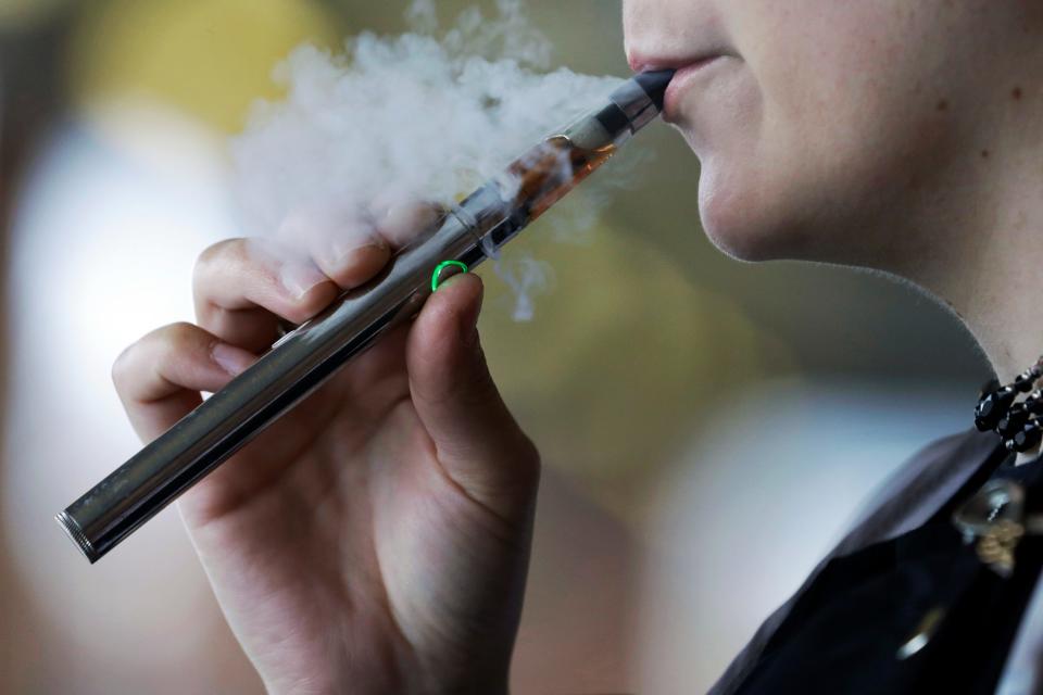 A woman using an electronic cigarette.