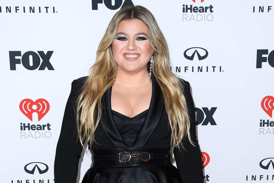 <p>Steve Granitz/FilmMagic</p> Kelly Clarkson poses at the 2023 iHeartRadio Music Awards in March