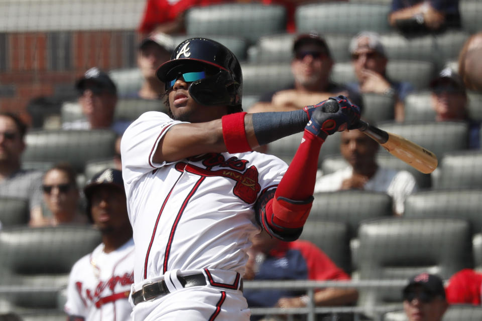 Atlanta Braves center fielder Ronald Acuna Jr. (13) follows through on a solo home run in the third inning of a baseball game against the Philadelphia Phillies Thursday, Sept. 19, 2019, in Atlanta. The homer was Acuna's 40th of the season. (AP Photo/John Bazemore)