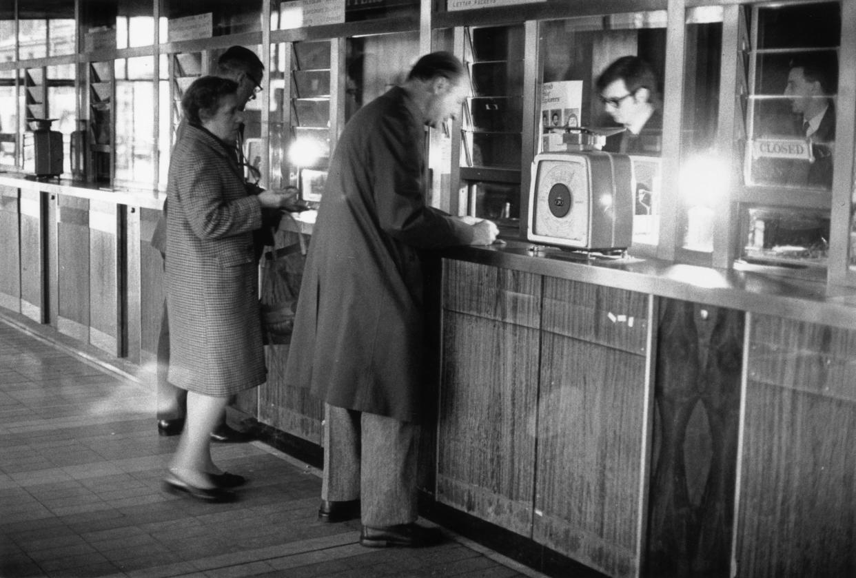 A post office in Trafalgar Square, London, functioning under emergency lamplight during an industrial power strike.   (Photo by Evening Standard/Getty Images)