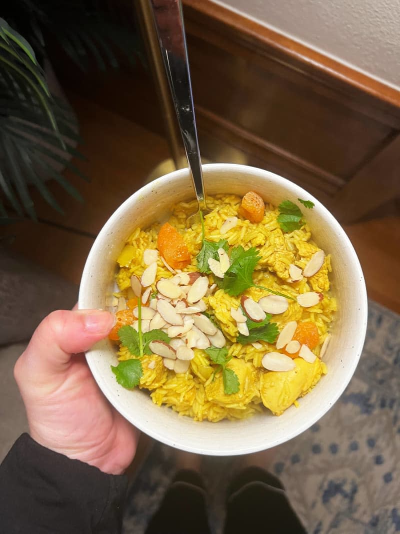 Bowl of yellow rice, with slivered almonds, and cilantro