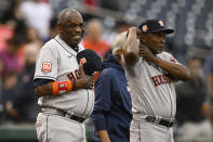 Houston Astros manager Dusty Baker Jr., left, looks on next to third base coach Gary Pettis, right, before a baseball game against the Washington Nationals, Saturday, May 14, 2022, in Washington. (AP Photo/Nick Wass)