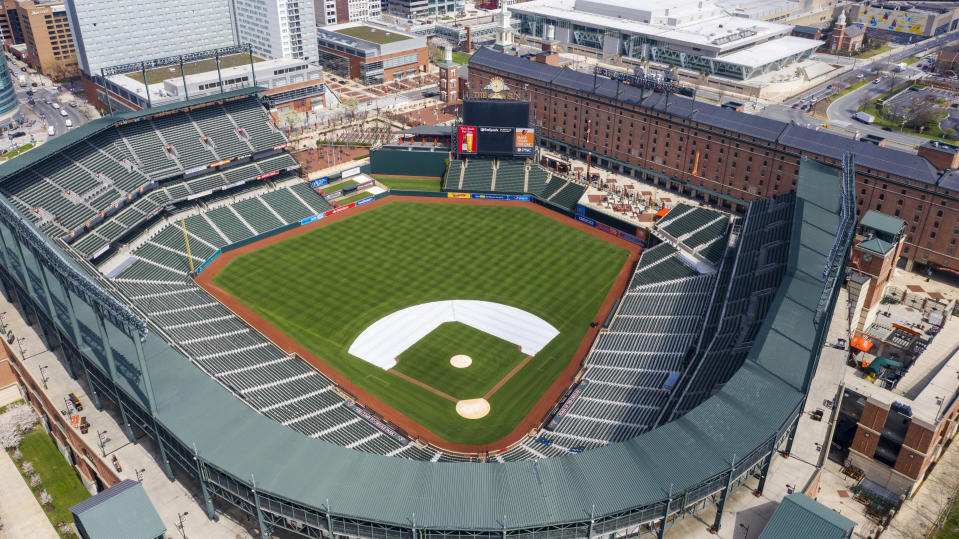 FILE - In this Thursday, March 26, 2020, file photo, Oriole Park at Camden Yards is closed on what would've been Opening Day in Baltimore, Md. Whenever baseball returns because of the coronavirus pandemic, there's an element that might come into play like never before: the sound of silence. (AP Photo/Steve Helber, File)