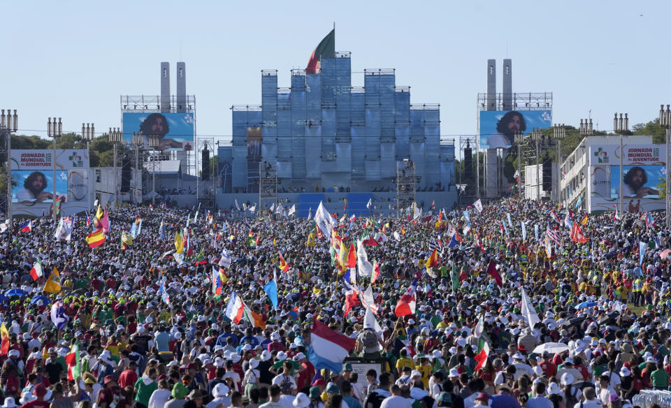 Worshipers attend a mass presided by the pope Francis at Lisbon's Parque Eduardo VII during a 'Via Crucis' (Way of the Cross) with young people participating into Sunday's 37th World Youth Day in the Portuguese capital, Friday, Aug. 4, 2023. Francis is in Portugal through the weekend to preside over the jamboree that St. John Paul II launched in the 1980s to encourage young Catholics in their faith. (AP Photo/Armando Franca)