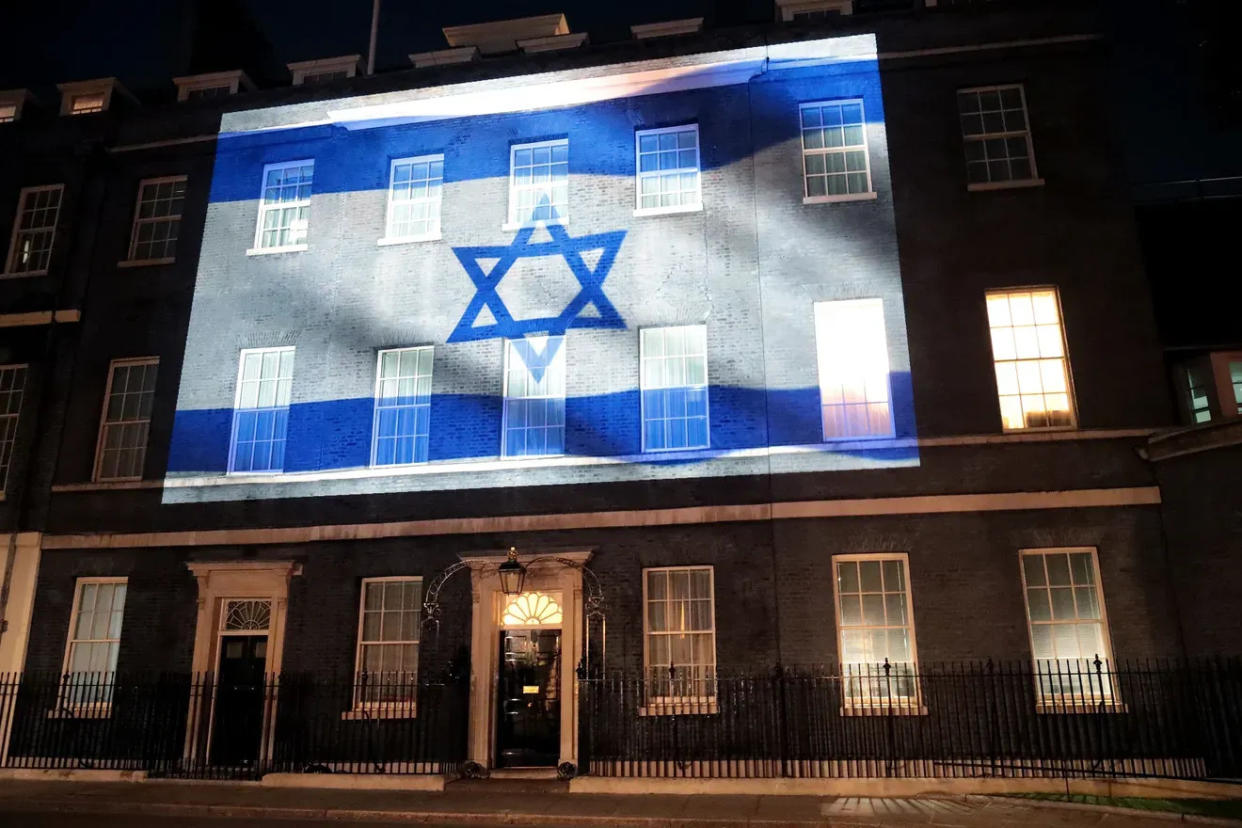 The Israeli flag is projected onto 10 Downing St., in London, the home of British prime ministers. Landmarks worldwide displayed the flag or its colors in a show of support a day after Israel suffered a deadly invasion from Gaza.
