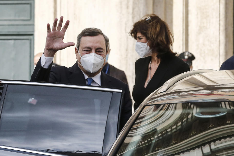 Former European Central Bank President Mario Draghi waves as he gets on a car after leaving the Chamber of Deputies following talks, in Rome, Wednesday, Feb. 3, 3021. Mario Draghi has agreed to try to form a non-political government to steer Italy through the coronavirus pandemic. (Cecilia Fabiano/LaPresse via AP)