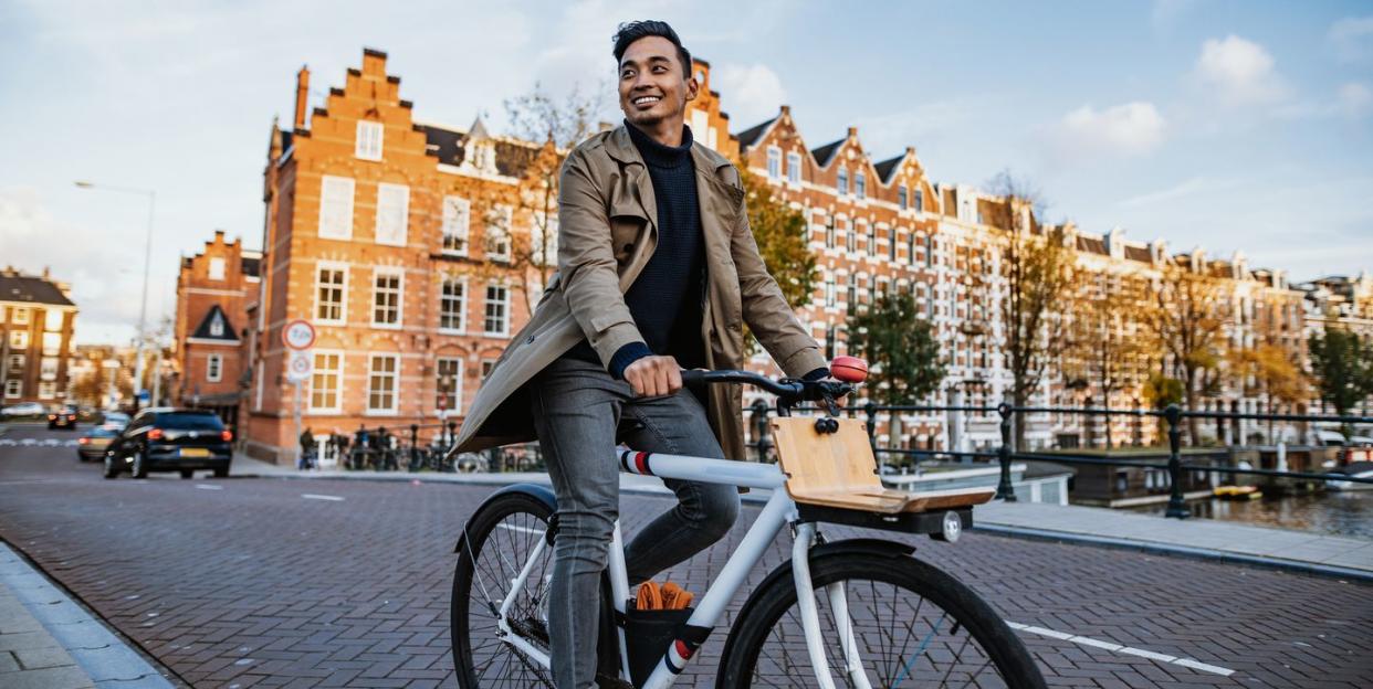 millennial asian tourist in the city with bicycle