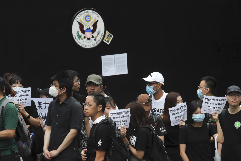 Protesters gather outside the U.S. Consulate as they stage a protest in Hong Kong, Wednesday, June 26, 2019. Hong Kong activists opposed to contentious extradition legislation on Wednesday called on leaders of the U.S., the European Union and others to raise the issue with Chinese President Xi Jinping at this week's G-20 summit in Japan. (AP Photo/Kin Cheung)