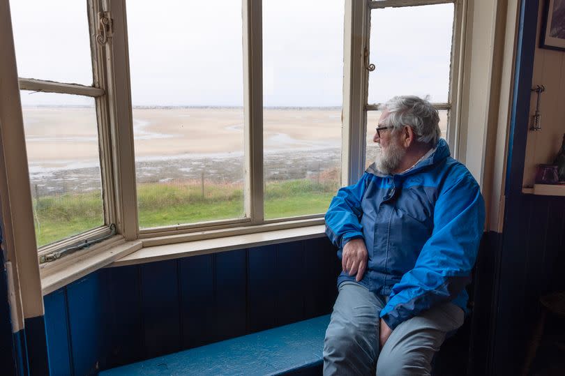 Mike looks out at the view from his bungalow on Hilbre Island