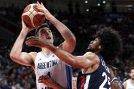 Luis Scola of Argentina puts up a shot over Louis Labeyrie of France during their semifinal match in the FIBA Basketball World Cup at the Cadillac Arena in Beijing, Friday, Sept. 13, 2019. (AP Photo/Mark Schiefelbein)