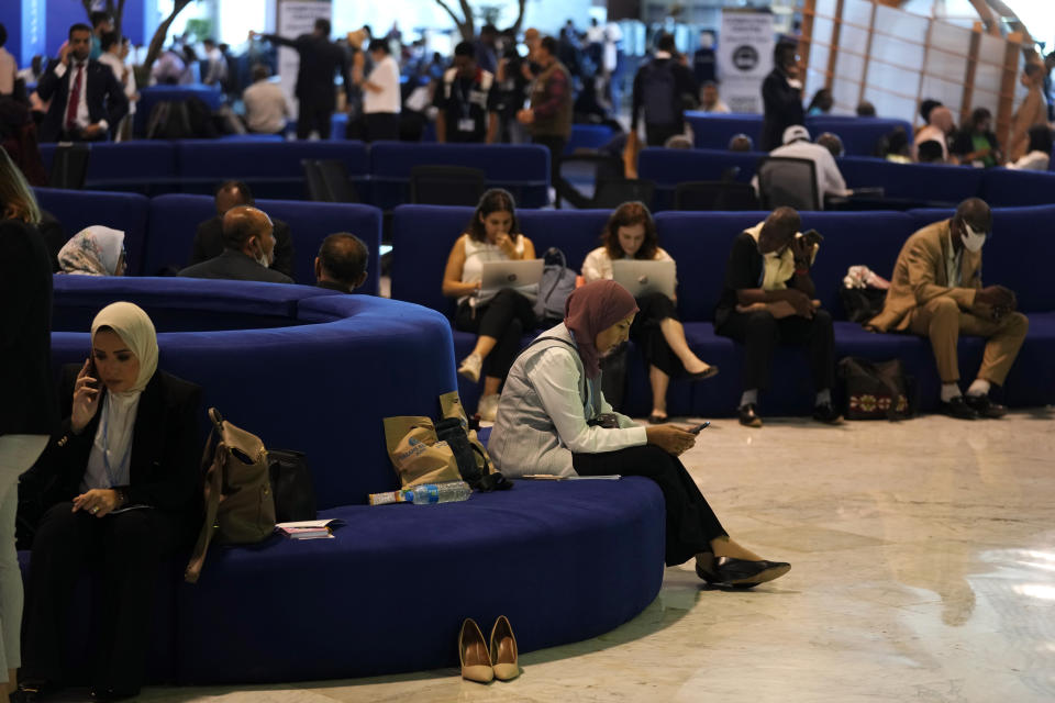 People wait for the opening session of the COP27 U.N. Climate Summit, Sunday, Nov. 6, 2022, in Sharm el-Sheikh, Egypt. (AP Photo/Peter Dejong)