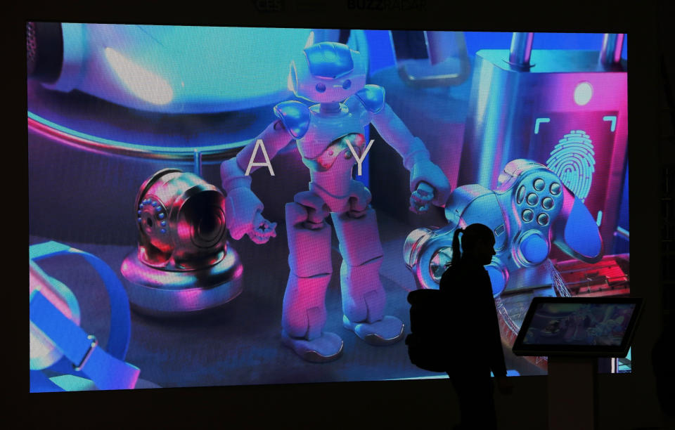 A person walks by a booth display before CES International, Saturday, Jan. 4, 2020, in Las Vegas. (AP Photo/John Locher)