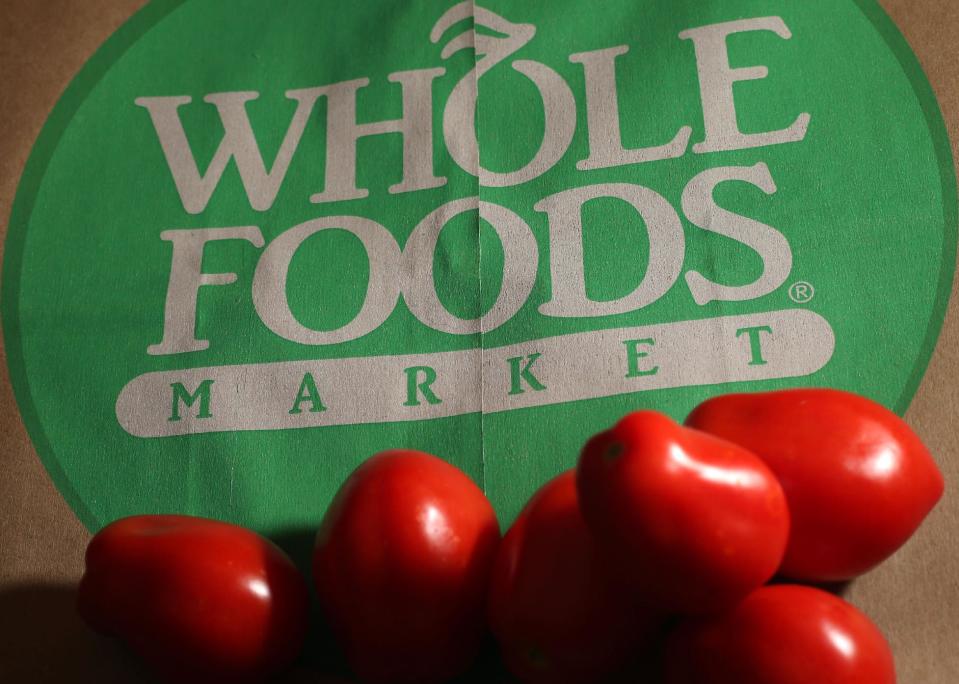 FILE - This July 29, 2013 file photo shows produce on a Whole Foods paper bag in Andover, Mass. Large food companies are trying to head off state-by-state efforts to enact mandatory labeling of genetically modified ingredients by proposing new voluntary labels nationwide. The food industry and farm groups are pushing Congress to pass legislation that would require the Food and Drug Administration to create guidelines for the new labels, which food manufacturers could use. (AP Photo/Elise Amendola, File)