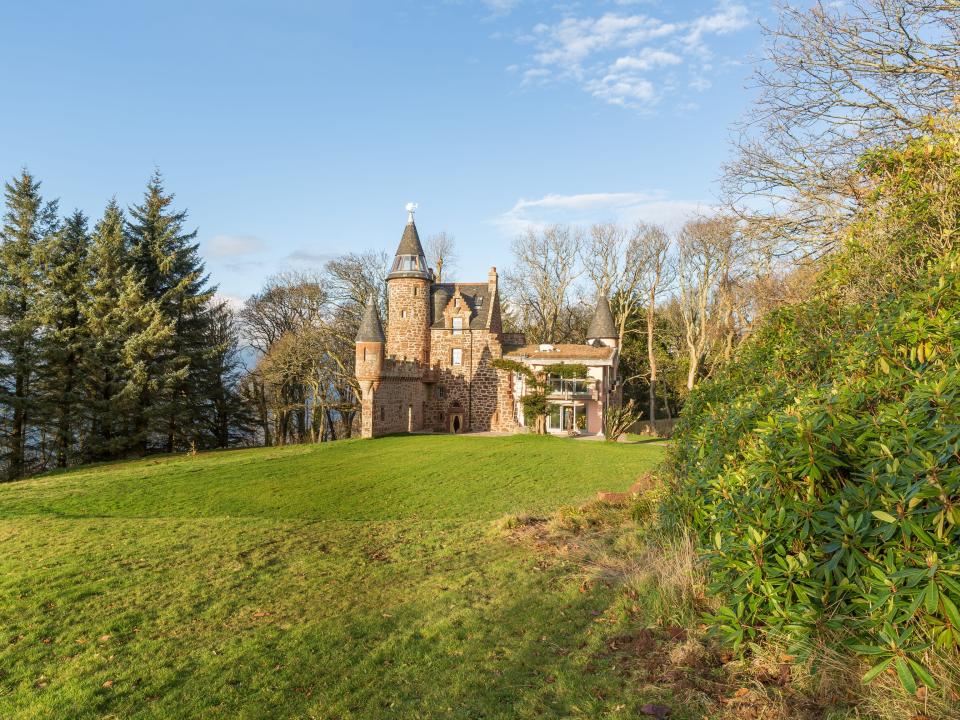 The castle is surrounded by greenery.