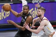 Brooklyn Nets' Kevin Durant, left, drives past Cleveland Cavaliers' Dean Wade during the first half of an NBA basketball game Sunday, May 16, 2021, in New York. (AP Photo/Frank Franklin II)