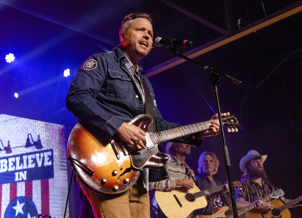 FILE - This March 9, 2020 file photo shows Jason Isbell, from left, Todd Snider, T.J. Osborne and Aaron Lee Tasjan performing at the To Nashville, With Love Benefit Concert in Nashville, Tenn. Isbell is king of the Americana genre, but he's ambitious for more. The new “Reunions” album reaches out sonically to people who might not normally listen to that type of music, but Isbell's well-crafted songs lie at the center of what he does. (Photo by Amy Harris/Invision/AP, File)