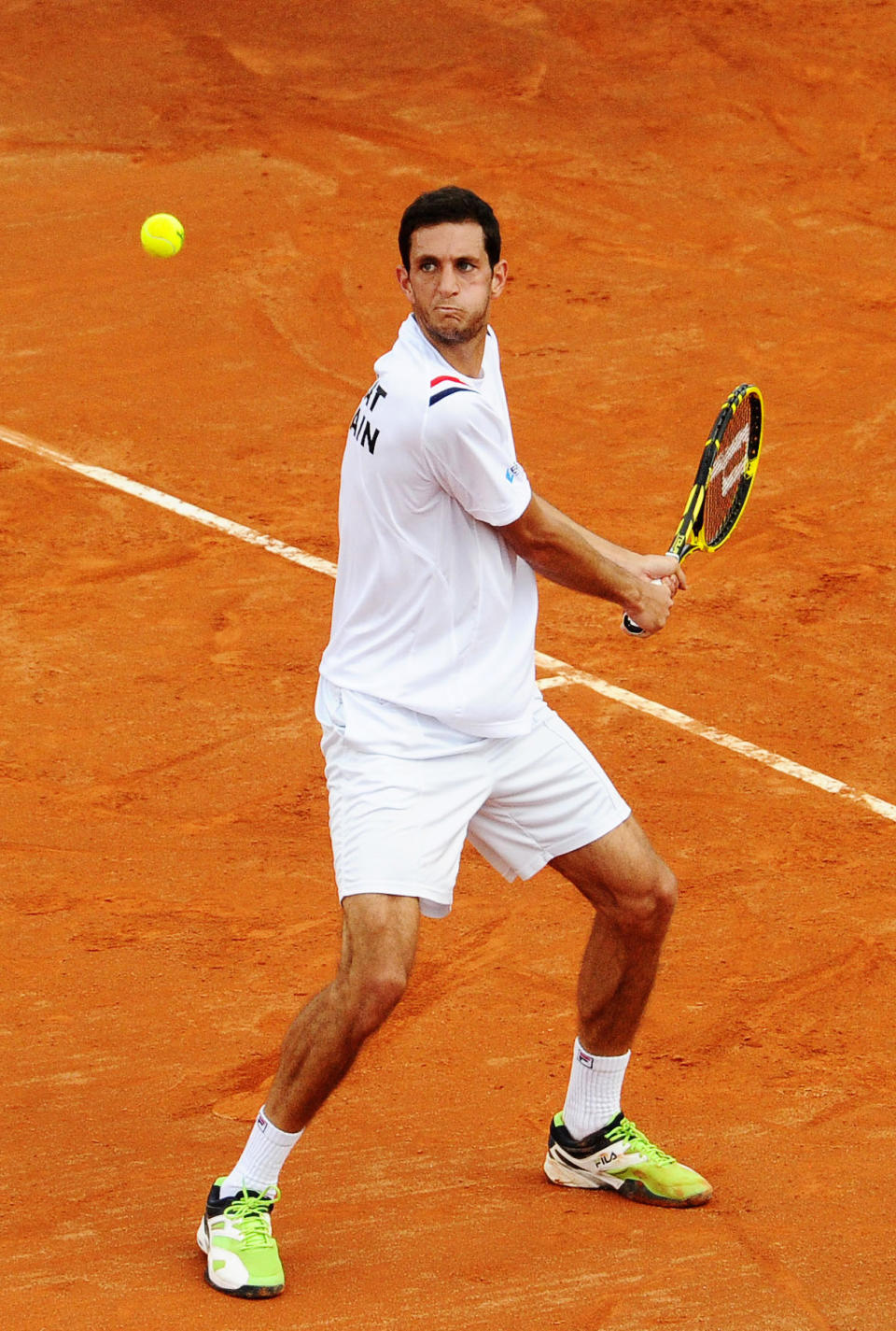 Britain's James Ward returns the ball to Italy's Fabio Fognini during their Davis Cup World Group quarterfinal match in Naples, Italy, Friday April 4, 2014. (AP Photo/Salvatore Laporta)